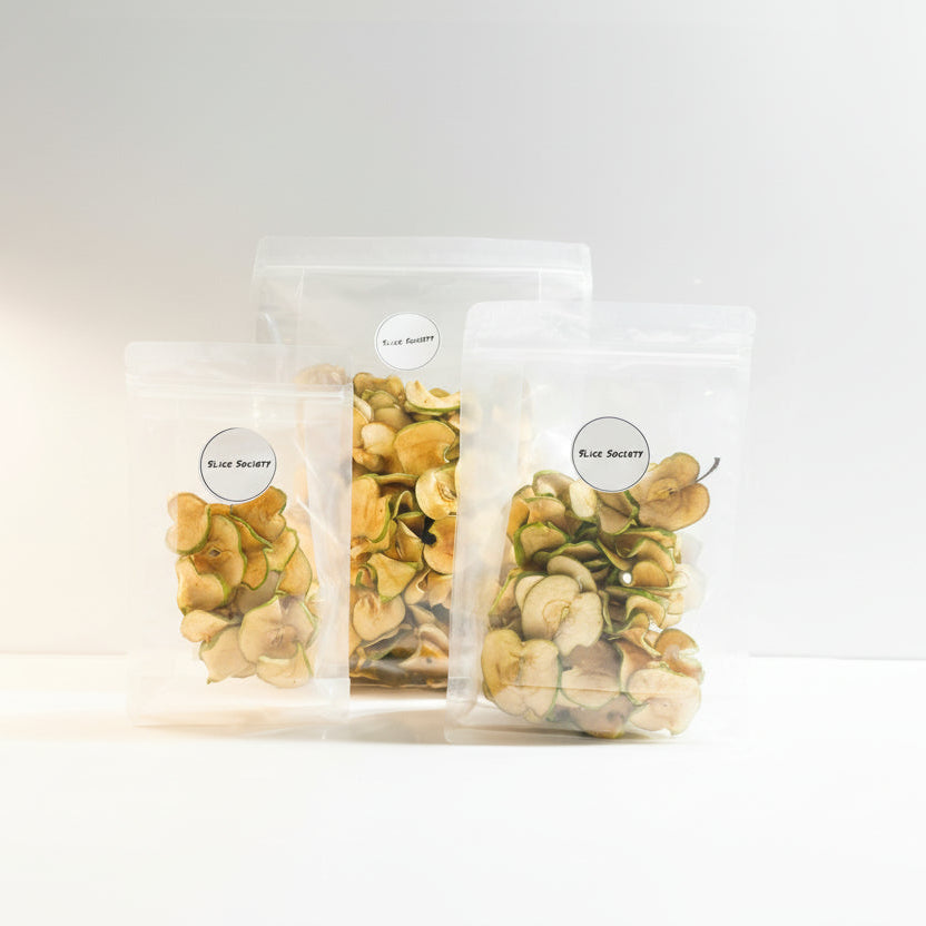 Three clear plastic bags with dried herbs labeled on a white background