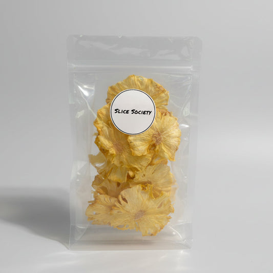 Dehydrated Pineapple in packaging with 'Slice Society' label on a clear background